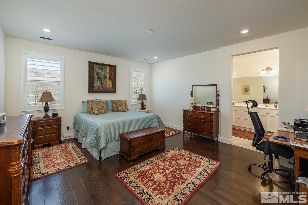 4501 High Pointe Drive Reno, NV 89521 - Photo 4 of 26 a bedroom with a bed a table and chair