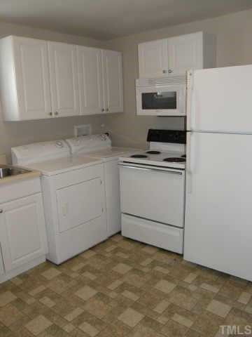 219 Gilbert Avenue Raleigh, NC 27603 - Photo 3 of 12 The kitchen separates the office suite from the residence. It has two doors so that either side can use the kitchen but be shut off from this point on. Other