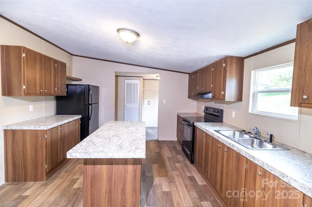 a kitchen with sink cabinets and wooden floor