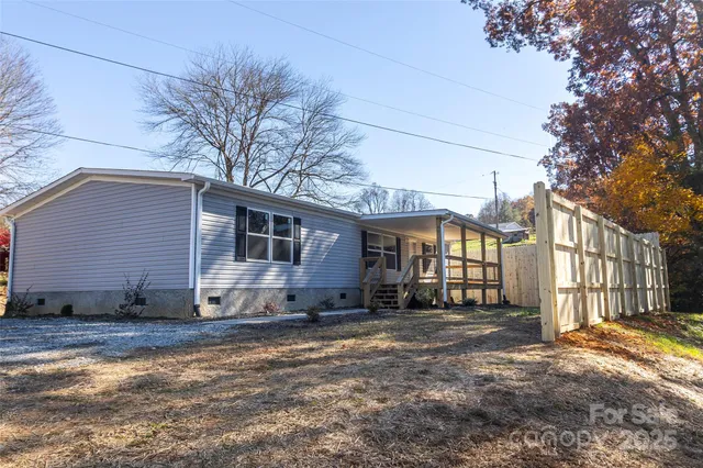 a view of a house with a yard covered in snow