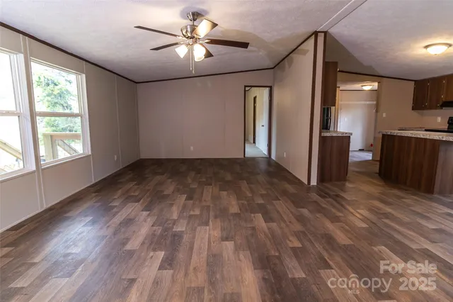 a view of empty room with wooden floor