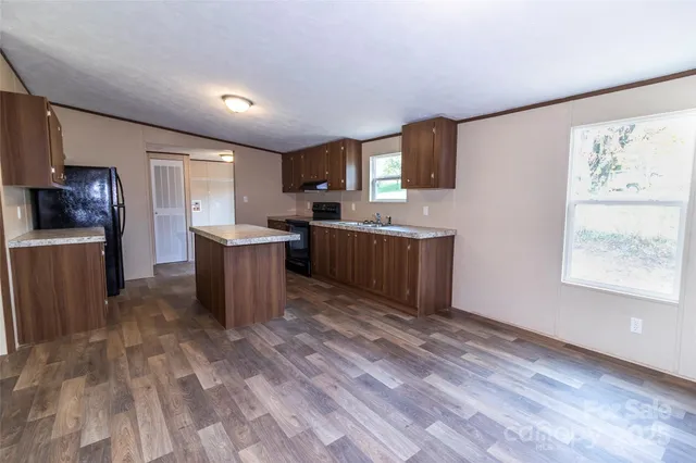 a kitchen with a sink and a stove top oven
