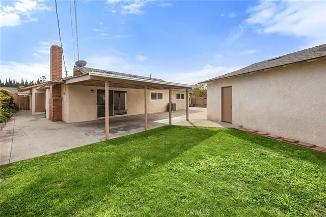 a backyard of a house with childrens swings and slides