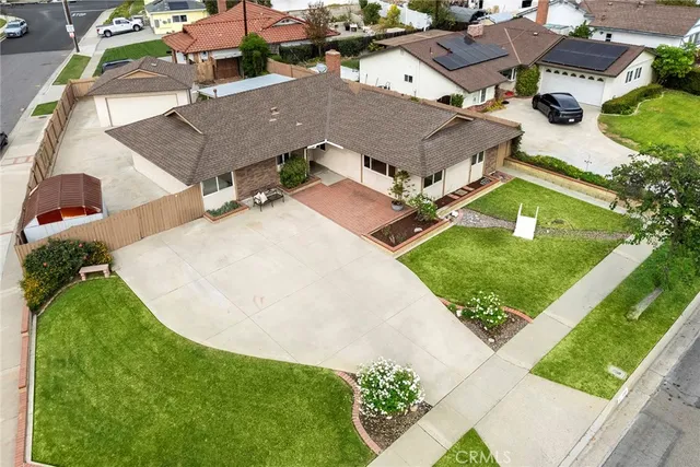 an aerial view of residential houses with outdoor space and street view