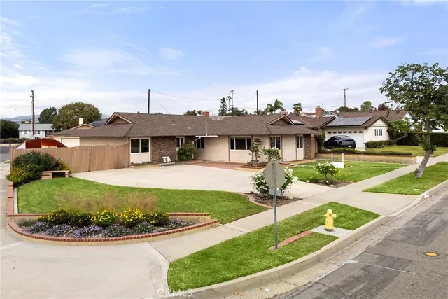 a view of a house with sitting area and garden