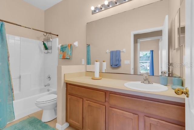 5120 Shale Ridge Trail Orlando, FL 32818 - Photo 14 of 15 a bathroom with a granite countertop sink a toilet and shower