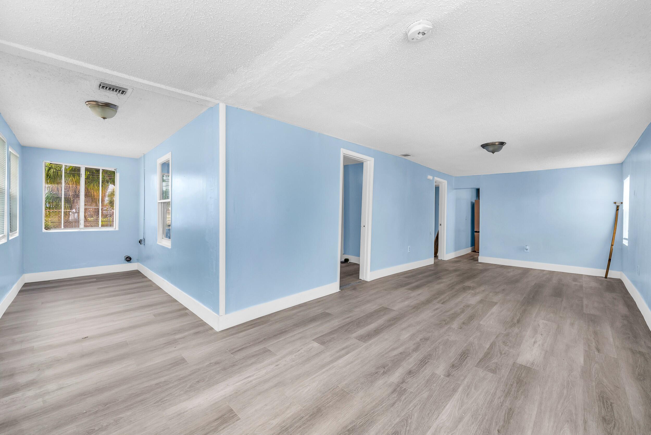1497 Silver Beach Road Riviera Beach, FL 33404 - Photo 4 of 14 a view of an empty room with window and wooden floor