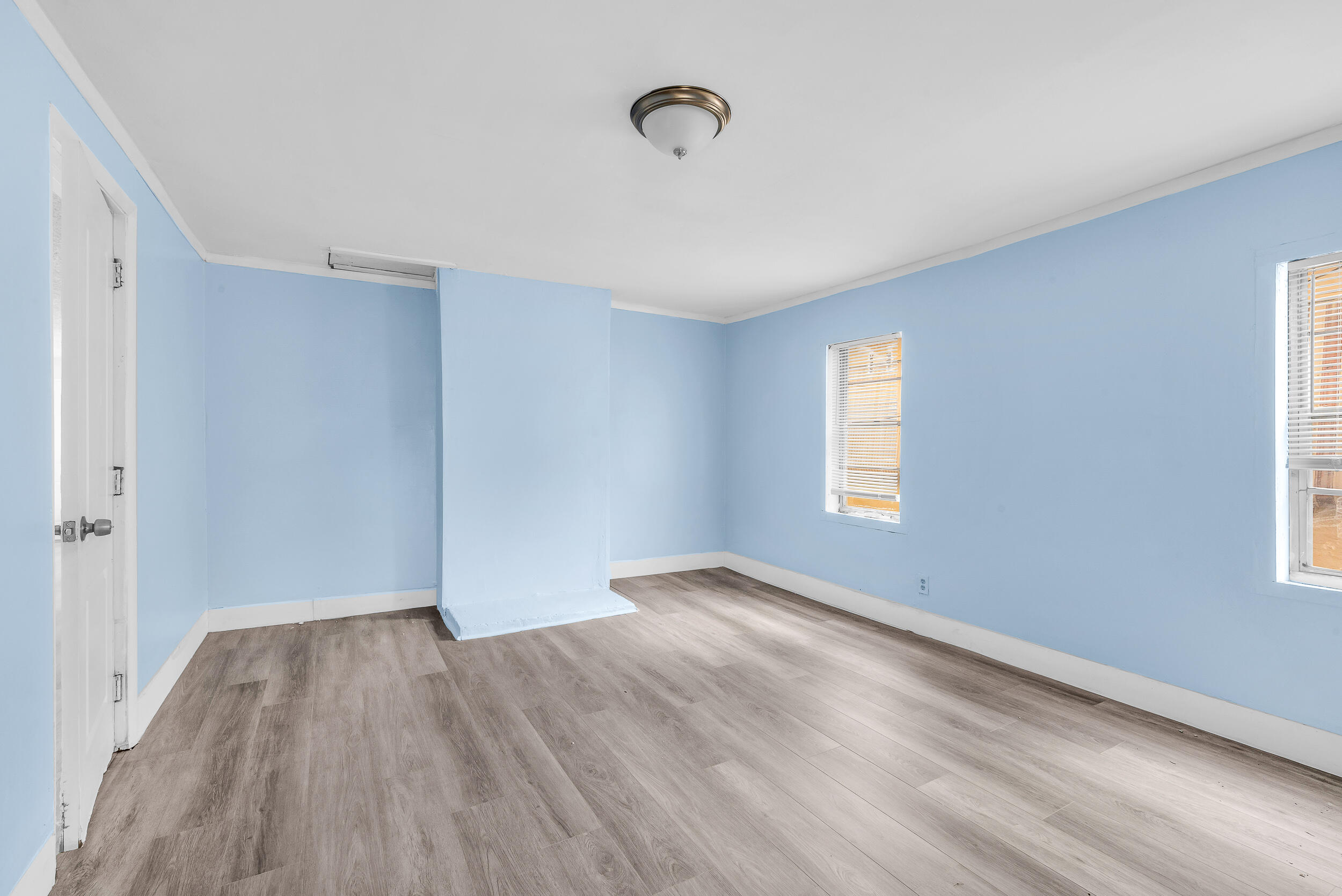 1497 Silver Beach Road Riviera Beach, FL 33404 - Photo 8 of 14 a view of an empty room with wooden floor and a window