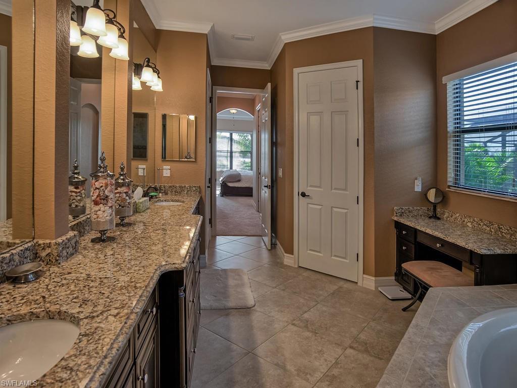 9634 Firenze Circle Naples, FL 34113 - Photo 14 of 35 a spacious bathroom with a granite countertop sink a mirror and shower