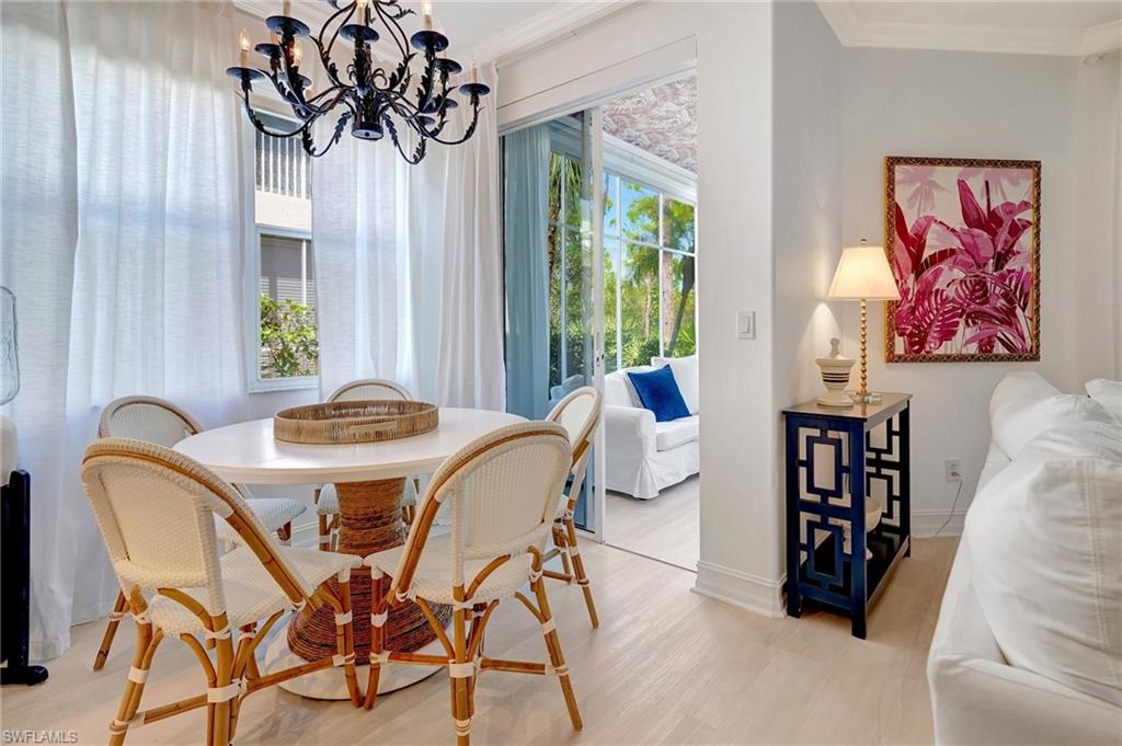 889 Carrick Bend Circle, Unit 1701 Naples, FL 34110 - Photo 12 of 32 a view of a dining room with furniture and window