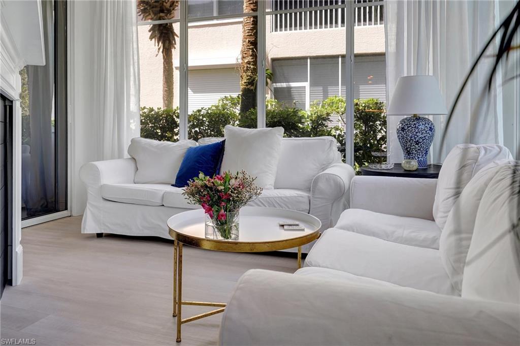 889 Carrick Bend Circle, Unit 1701 Naples, FL 34110 - Photo 13 of 32 a living room with furniture and a potted plant