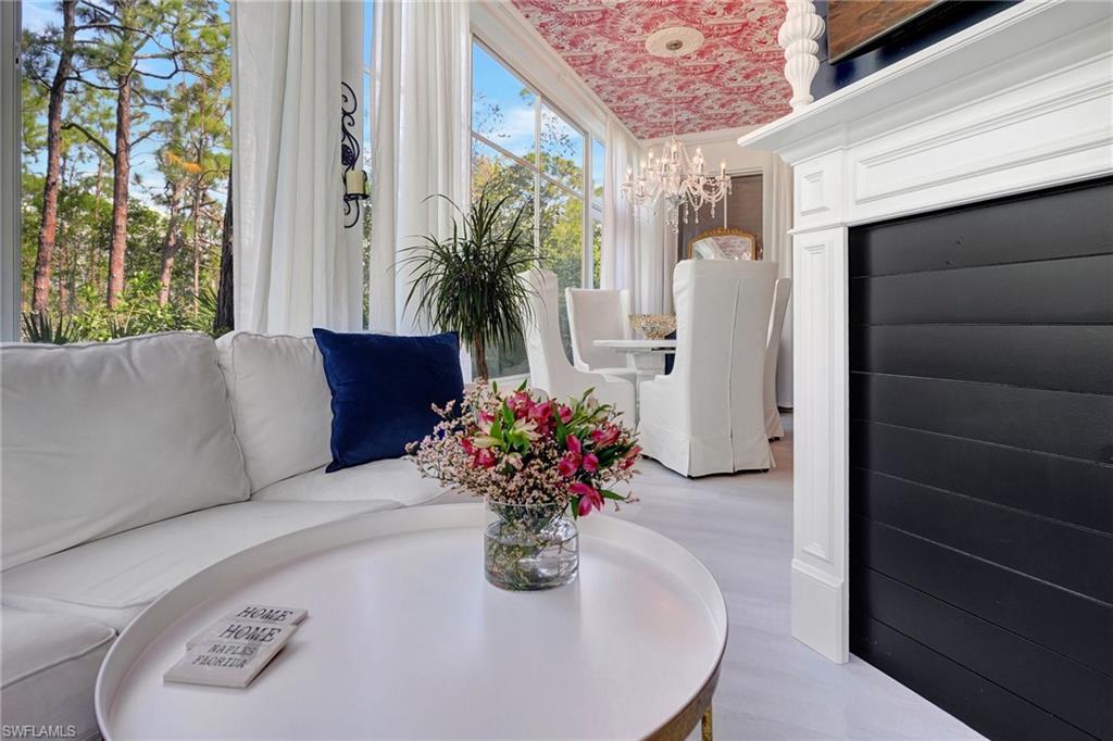 889 Carrick Bend Circle, Unit 1701 Naples, FL 34110 - Photo 16 of 32 a dining room with furniture and flowers