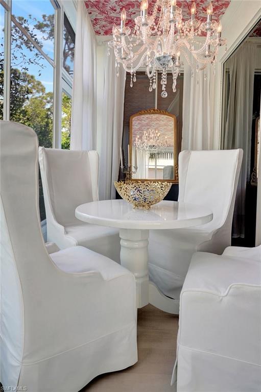 889 Carrick Bend Circle, Unit 1701 Naples, FL 34110 - Photo 17 of 32 a living room with furniture and a window