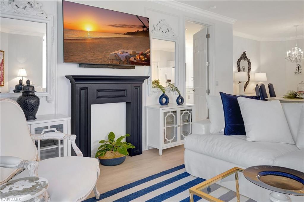 889 Carrick Bend Circle, Unit 1701 Naples, FL 34110 - Photo 19 of 32 a living room with furniture and a flat screen tv