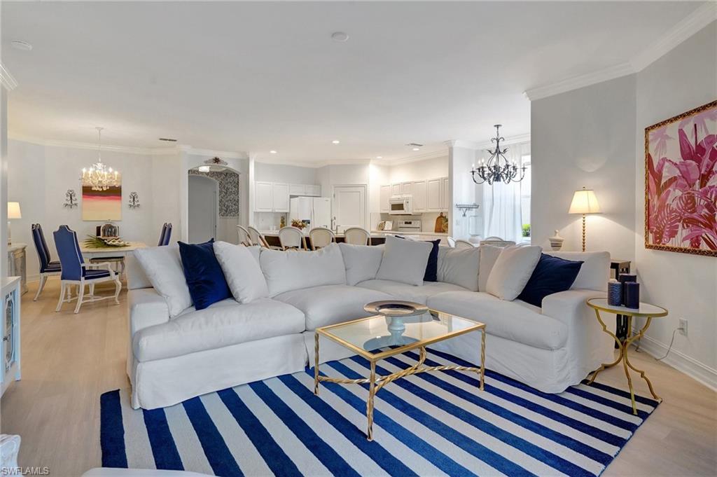 889 Carrick Bend Circle, Unit 1701 Naples, FL 34110 - Photo 20 of 32 a living room with furniture or couch and a dining table