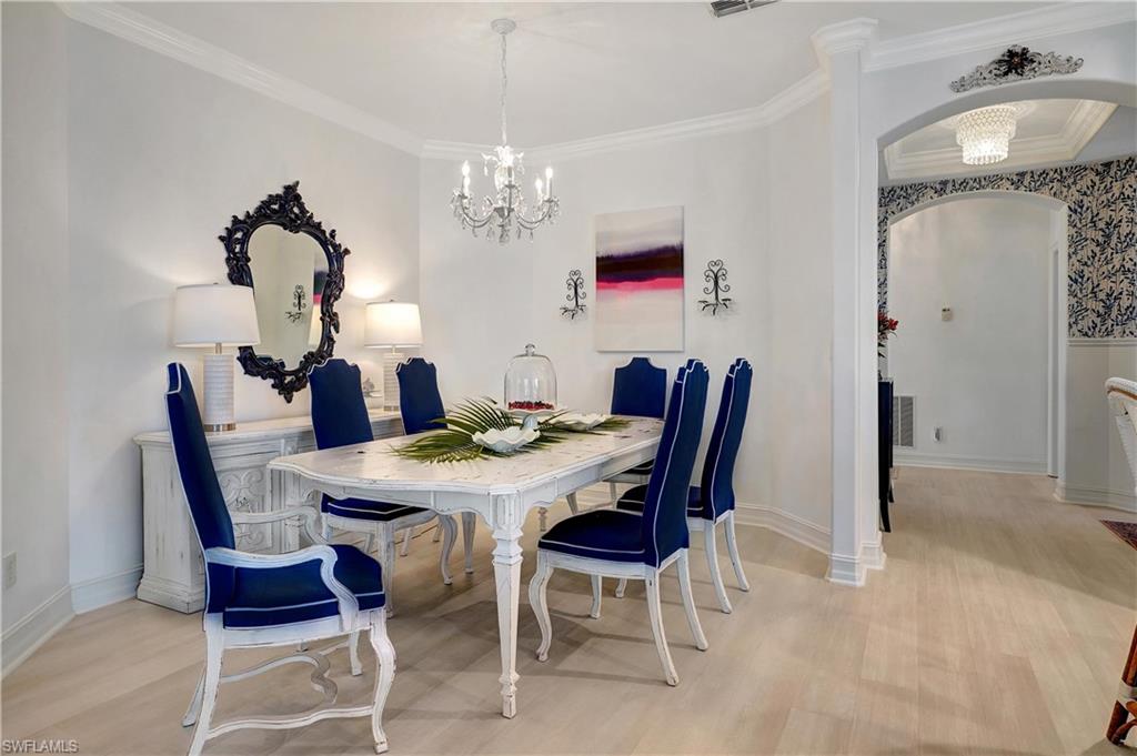 889 Carrick Bend Circle, Unit 1701 Naples, FL 34110 - Photo 21 of 32 a view of a dining room with furniture and chandelier