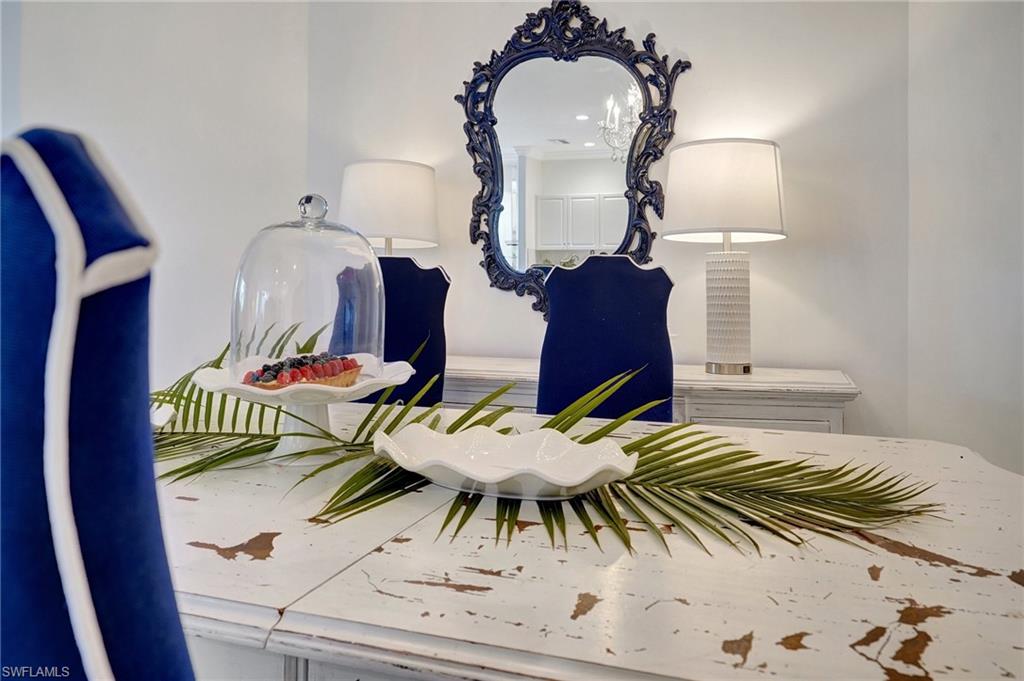 889 Carrick Bend Circle, Unit 1701 Naples, FL 34110 - Photo 22 of 32 a balcony with table and chairs