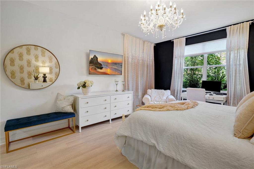 889 Carrick Bend Circle, Unit 1701 Naples, FL 34110 - Photo 25 of 32 a bedroom with furniture and a window