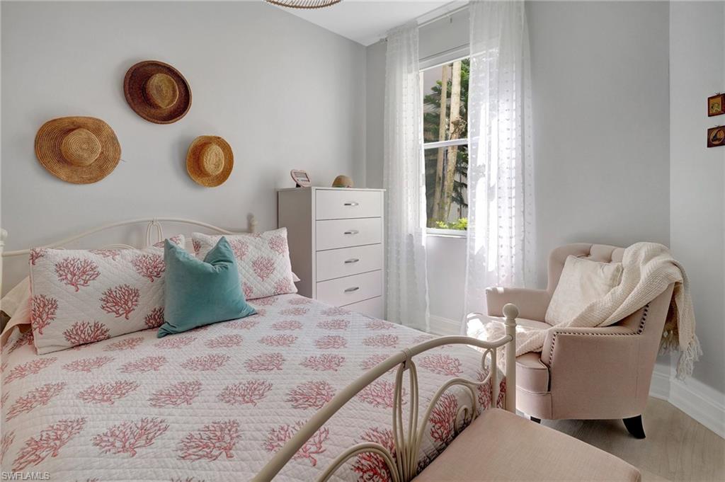 889 Carrick Bend Circle, Unit 1701 Naples, FL 34110 - Photo 29 of 32 a bedroom with a bed and a window