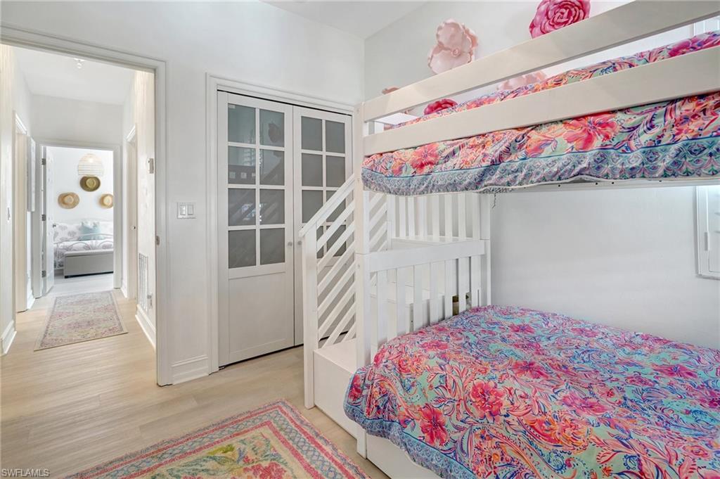 889 Carrick Bend Circle, Unit 1701 Naples, FL 34110 - Photo 30 of 32 a bedroom with a bed and a window