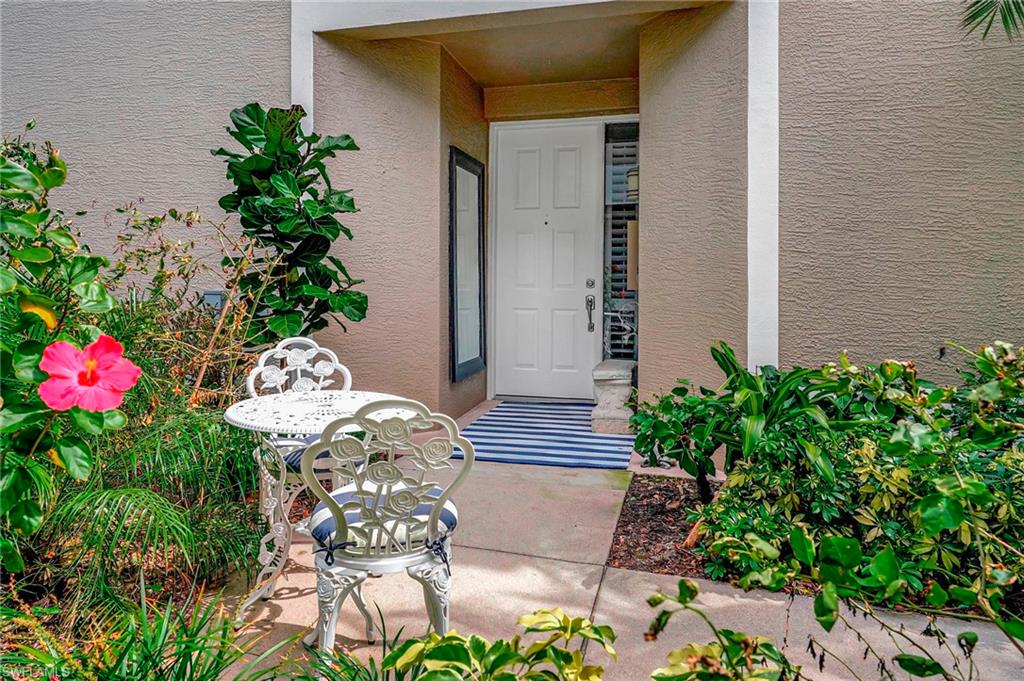889 Carrick Bend Circle, Unit 1701 Naples, FL 34110 - Photo 3 of 32 a vase of flowers sitting on a floor