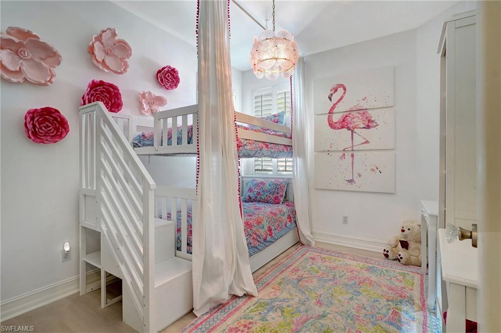 889 Carrick Bend Circle, Unit 1701 Naples, FL 34110 - Photo 31 of 32 kids room with toys and a chandelier