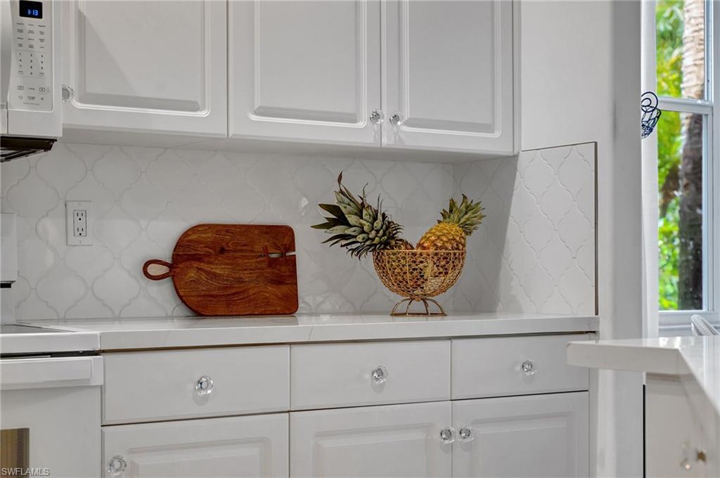 889 Carrick Bend Circle, Unit 1701 Naples, FL 34110 - Photo 8 of 32 a view of white cabinets and a potted plant