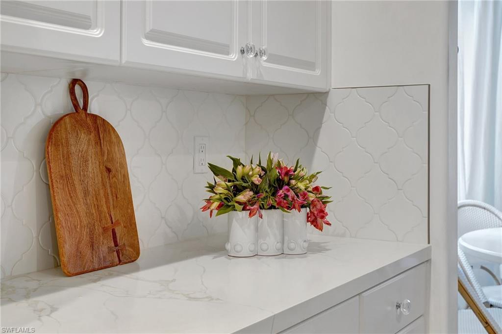 889 Carrick Bend Circle, Unit 1701 Naples, FL 34110 - Photo 9 of 32 a white vase with flowers