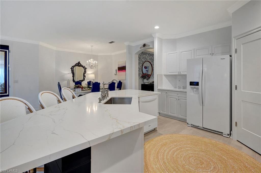 889 Carrick Bend Circle, Unit 1701 Naples, FL 34110 - Photo 10 of 32 a view of a kitchen counter space and appliances