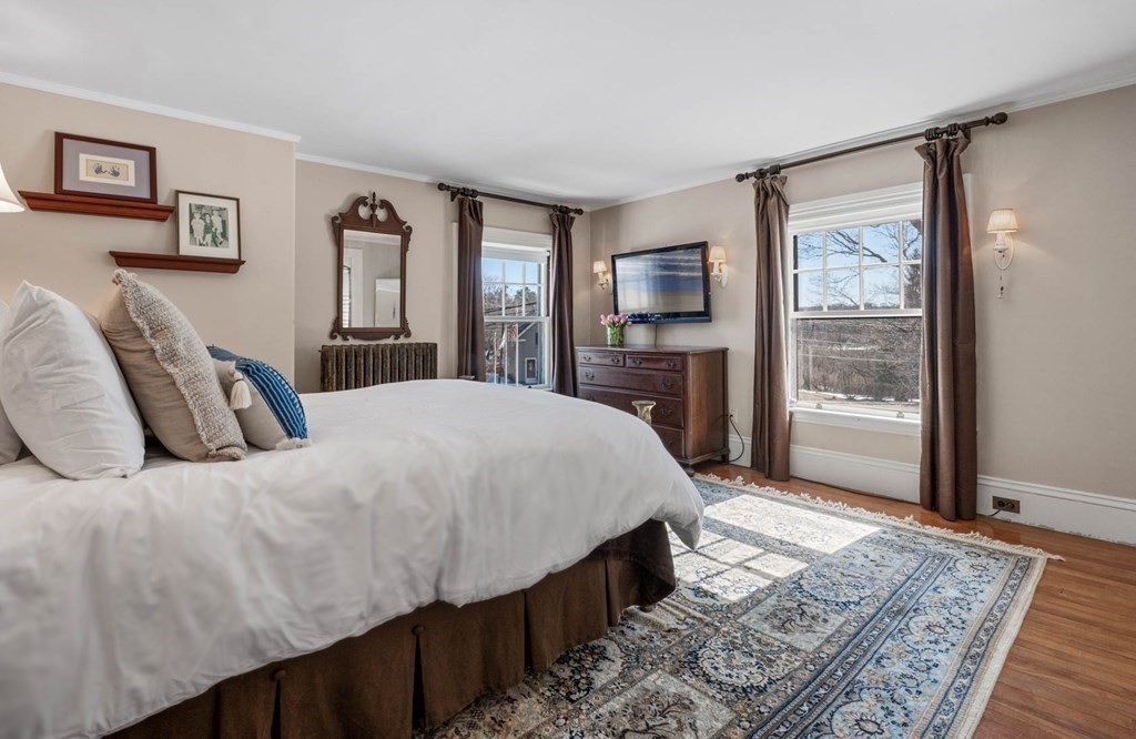 2 South Hampton Road Amesbury, MA 01913 - Photo 16 of 32 a bed sitting in a bedroom next to a window