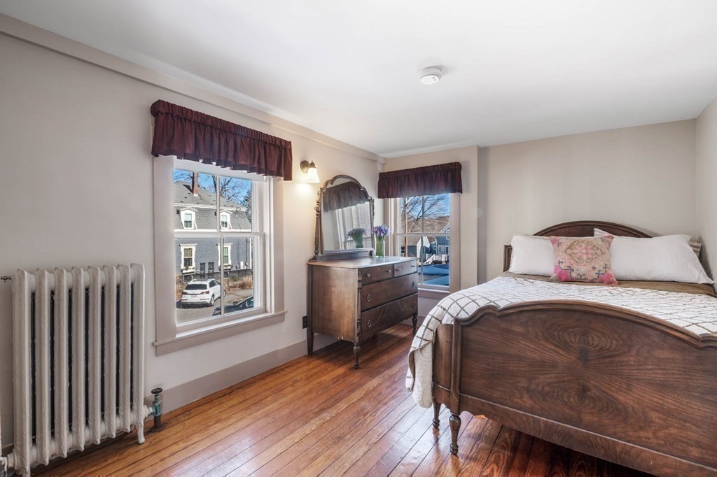 2 South Hampton Road Amesbury, MA 01913 - Photo 19 of 32 a bedroom with a bed and wooden floor