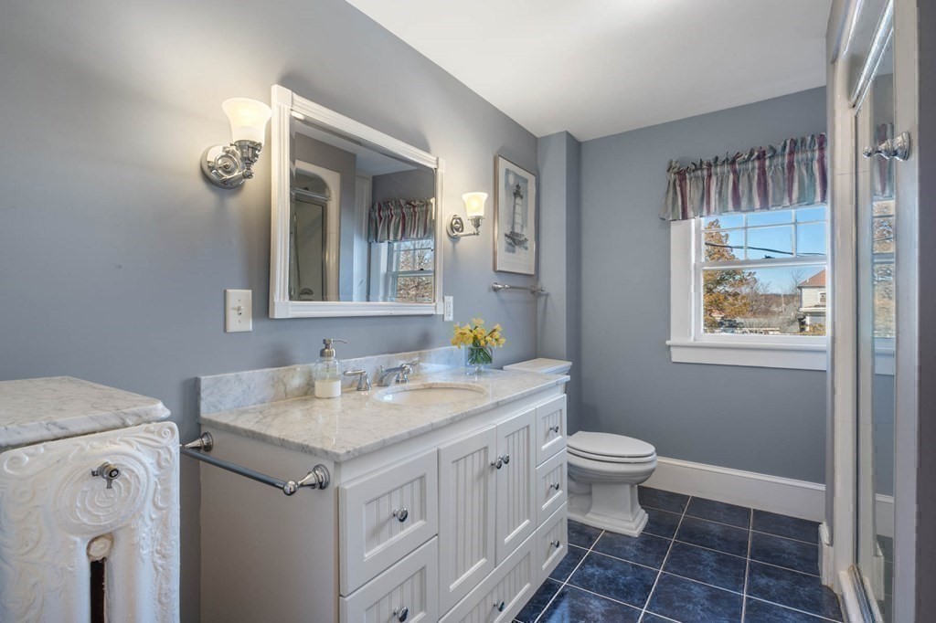 2 South Hampton Road Amesbury, MA 01913 - Photo 21 of 32 a bathroom with a granite countertop sink mirror and toilet