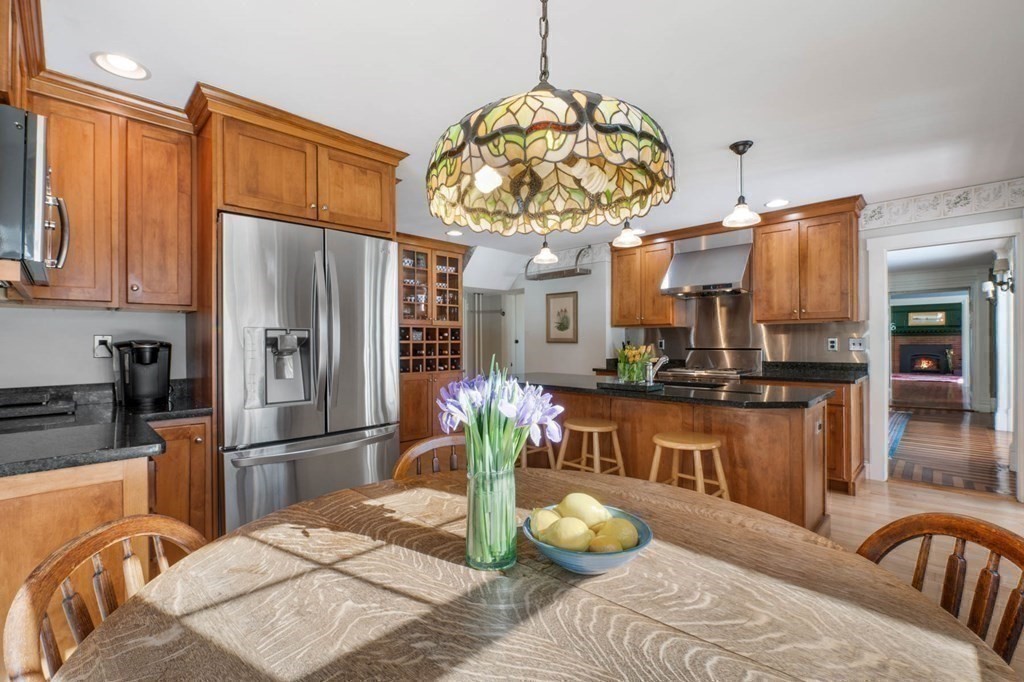 2 South Hampton Road Amesbury, MA 01913 - Photo 8 of 32 a kitchen with stainless steel appliances granite countertop a refrigerator and a stove top oven