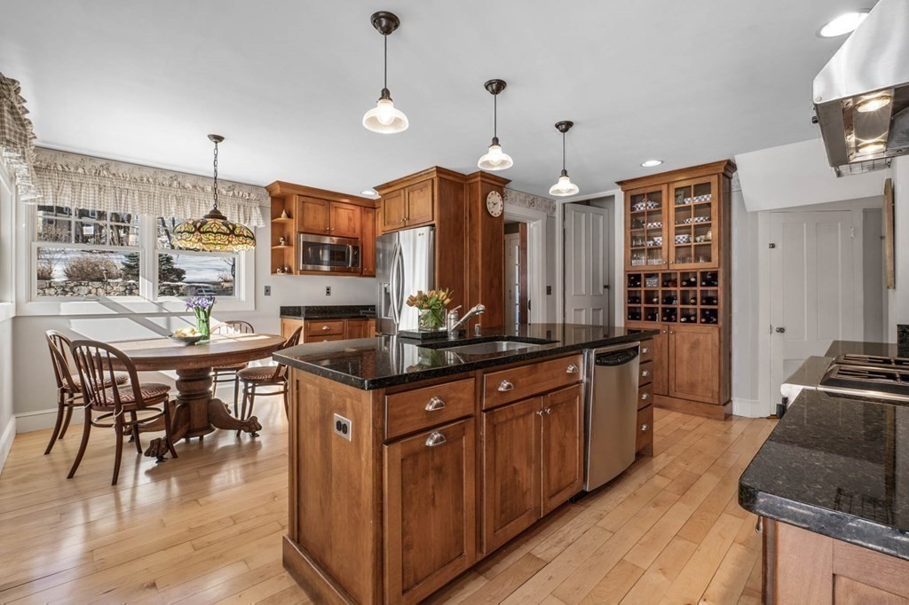2 South Hampton Road Amesbury, MA 01913 - Photo 9 of 32 a kitchen with stainless steel appliances granite countertop a stove a sink dishwasher and a refrigerator with wooden floor
