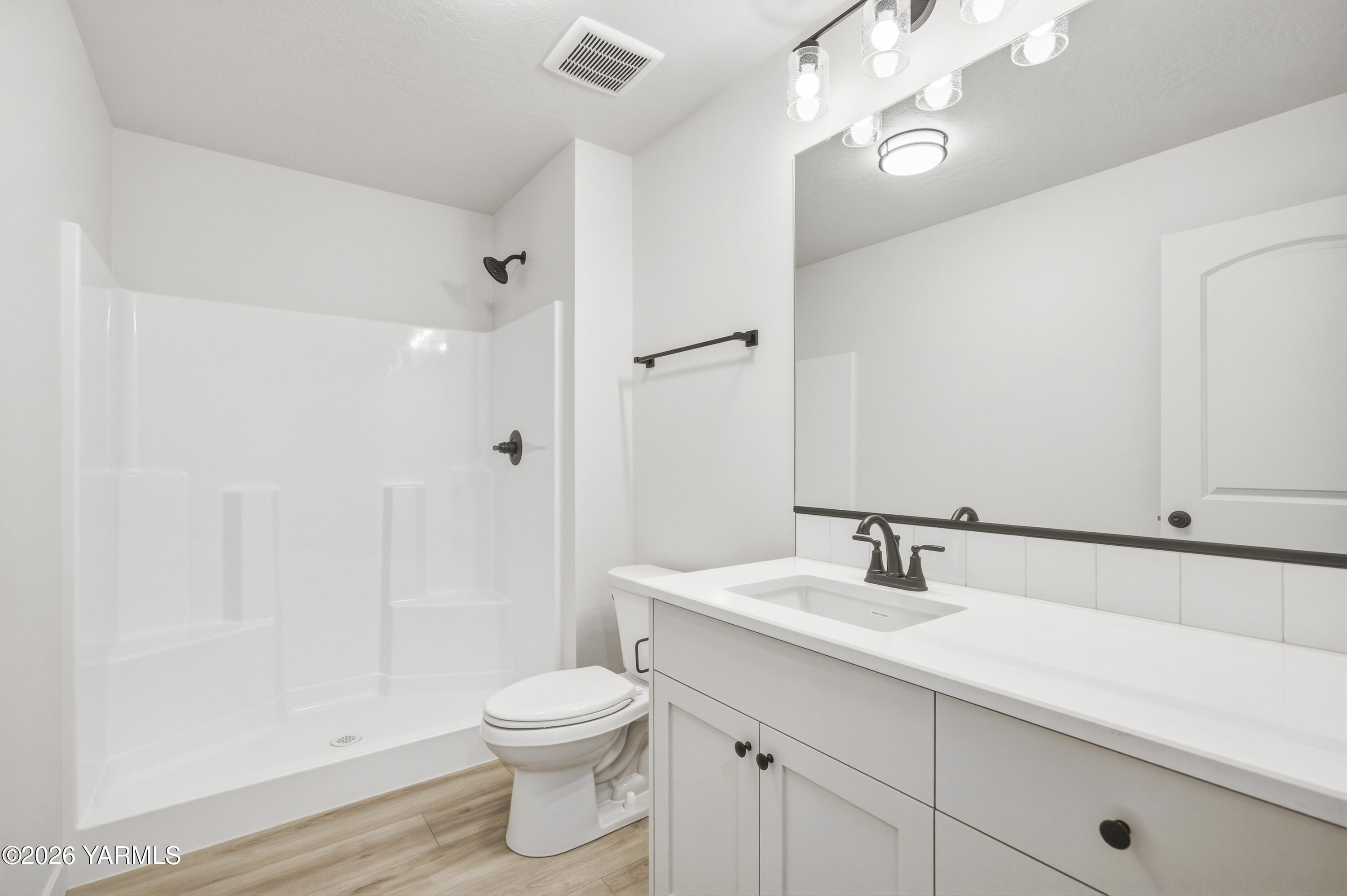 215 Packer Street Prosser, WA 99350 - Photo 16 of 45 a bathroom with a sink a toilet and shower