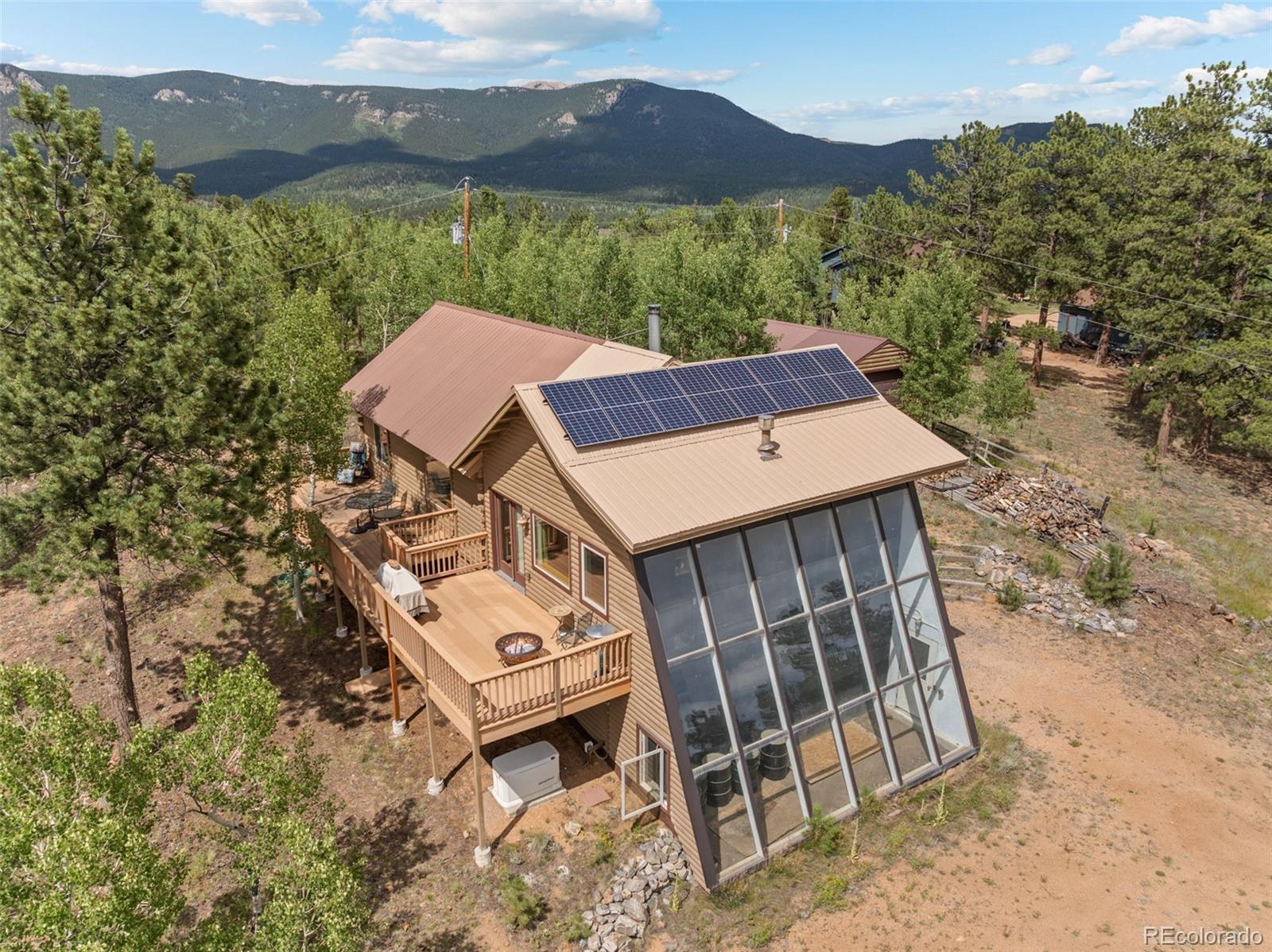 an aerial view of a house with a mountain