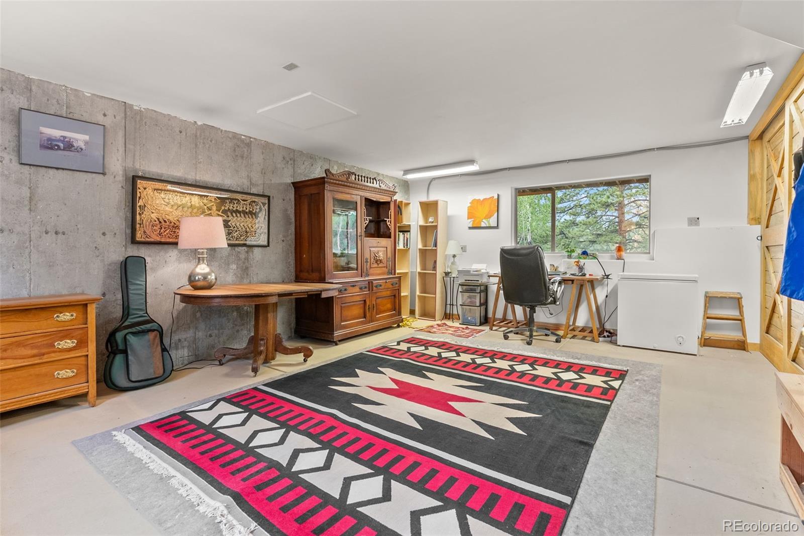62 Quartz Circle Bailey, CO 80421 - Photo 31 of 38 a living room with furniture a rug and a table