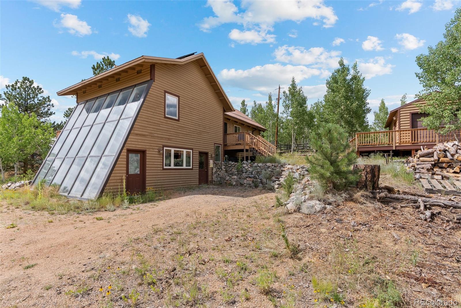 62 Quartz Circle Bailey, CO 80421 - Photo 32 of 38 a front view of a house with a yard