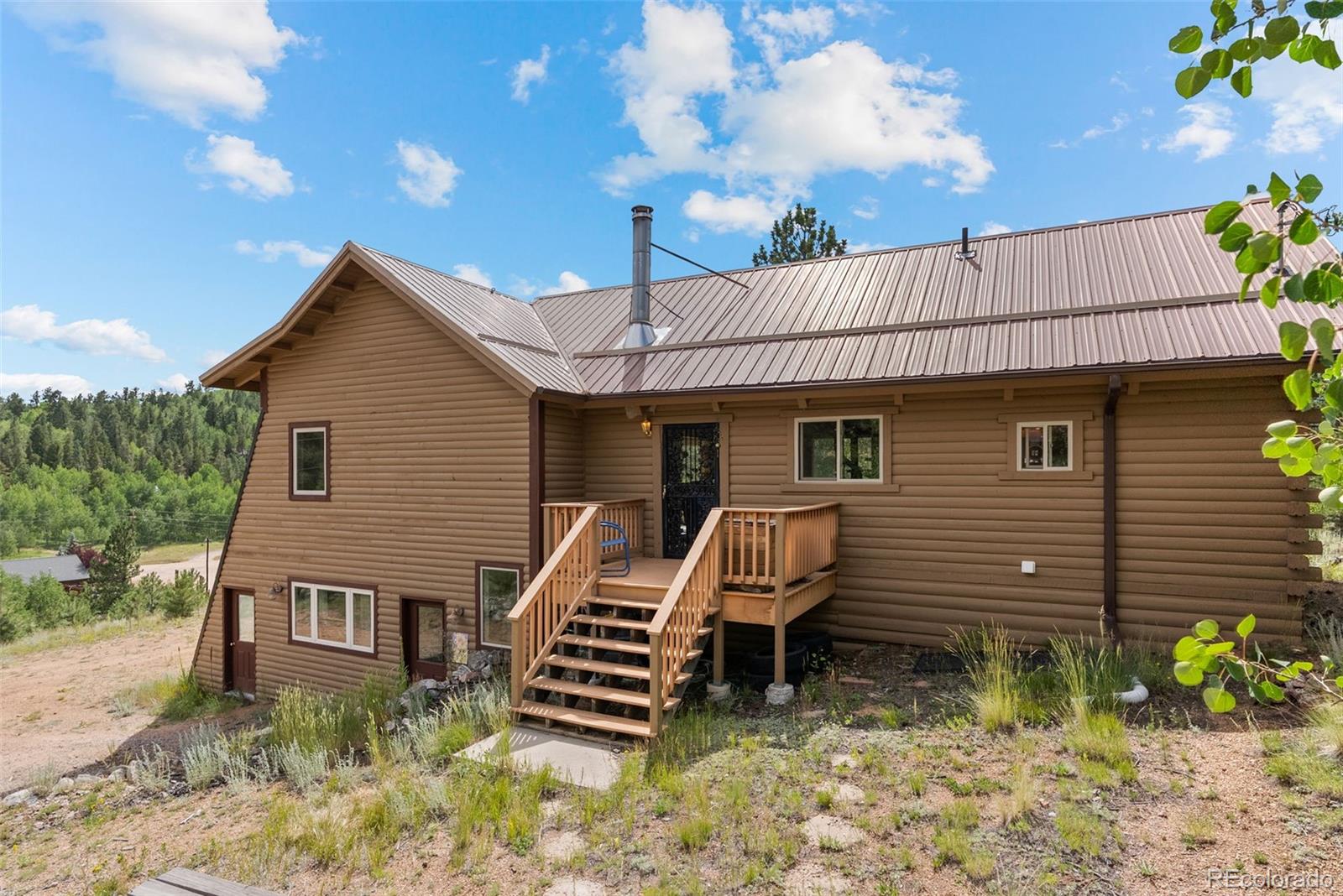 62 Quartz Circle Bailey, CO 80421 - Photo 7 of 38 a front view of a house with plants
