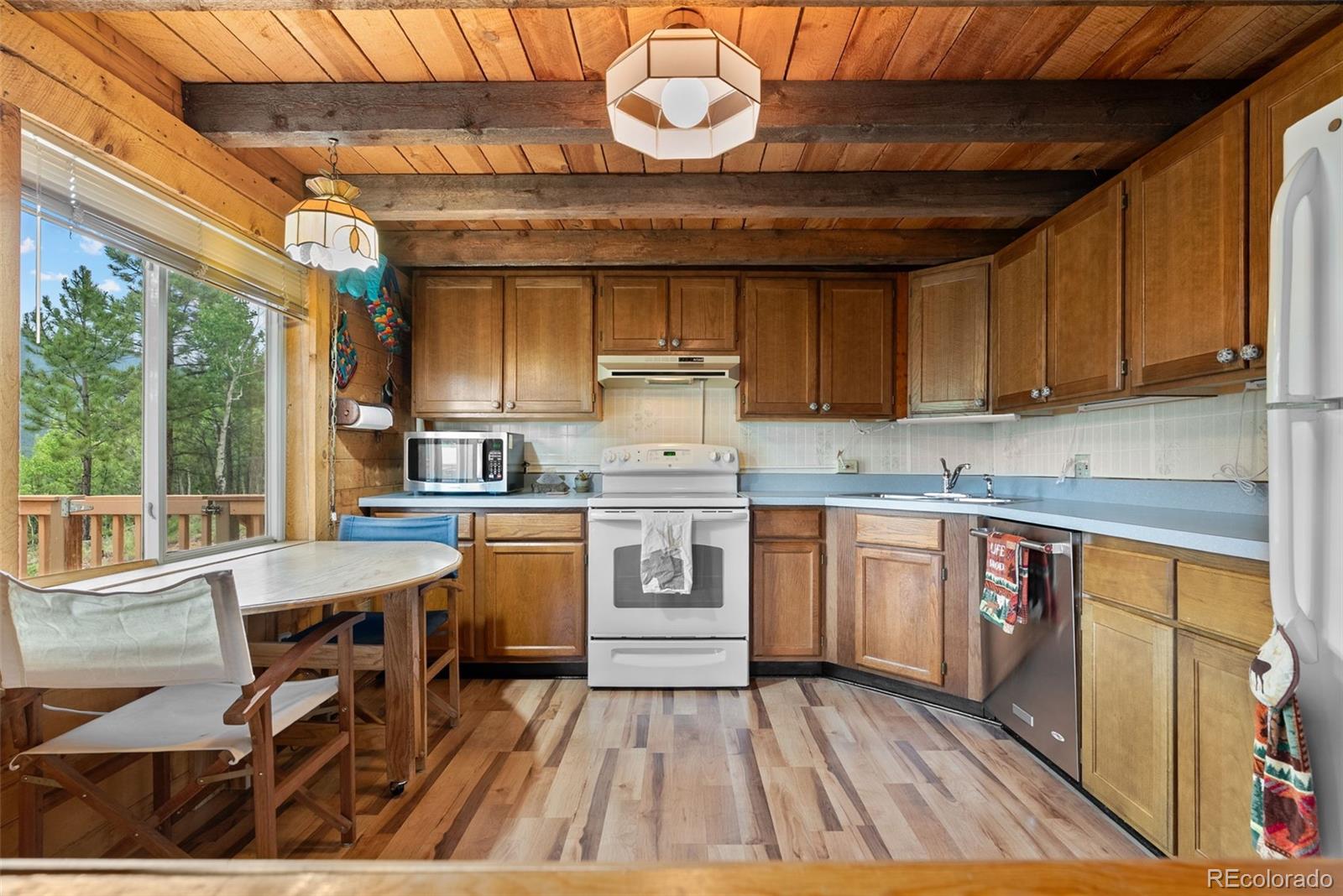 62 Quartz Circle Bailey, CO 80421 - Photo 9 of 38 a kitchen with a stove a sink and cabinets