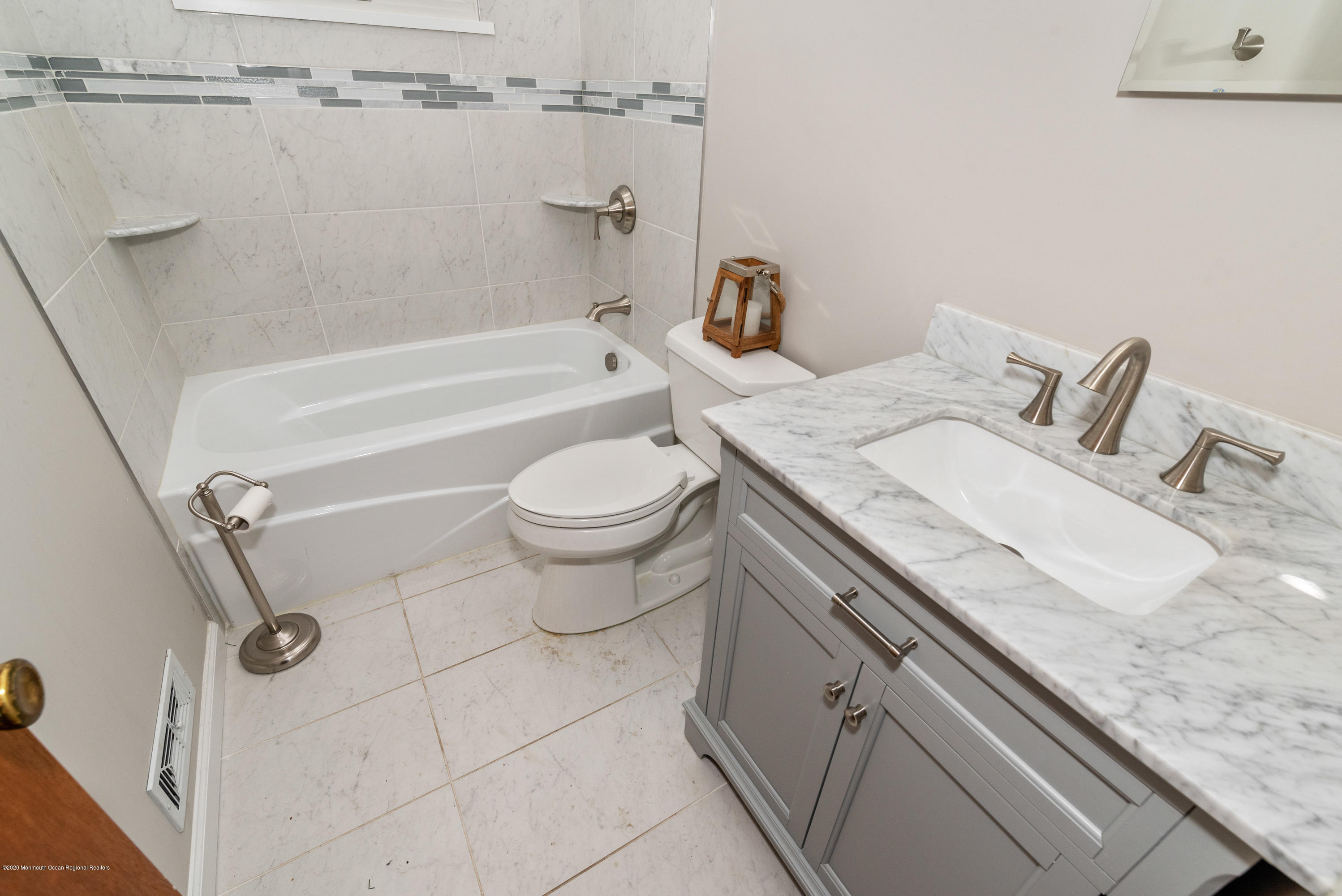 1313 Allaire Road Spring Lake, NJ 07762 - Photo 14 of 23 a bathroom with a granite countertop sink a toilet and bathtub