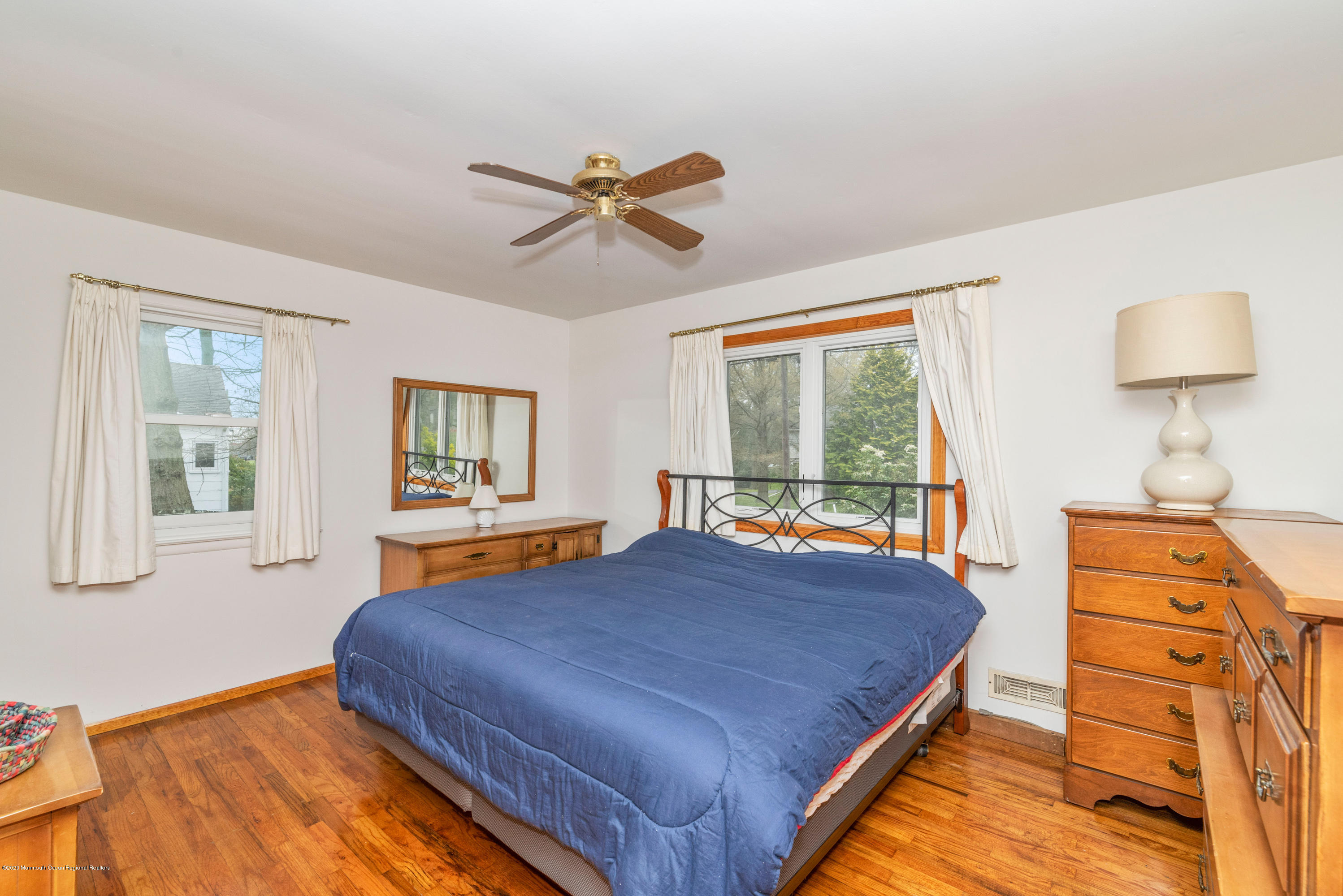 1313 Allaire Road Spring Lake, NJ 07762 - Photo 17 of 23 a bedroom with a bed and wooden floor