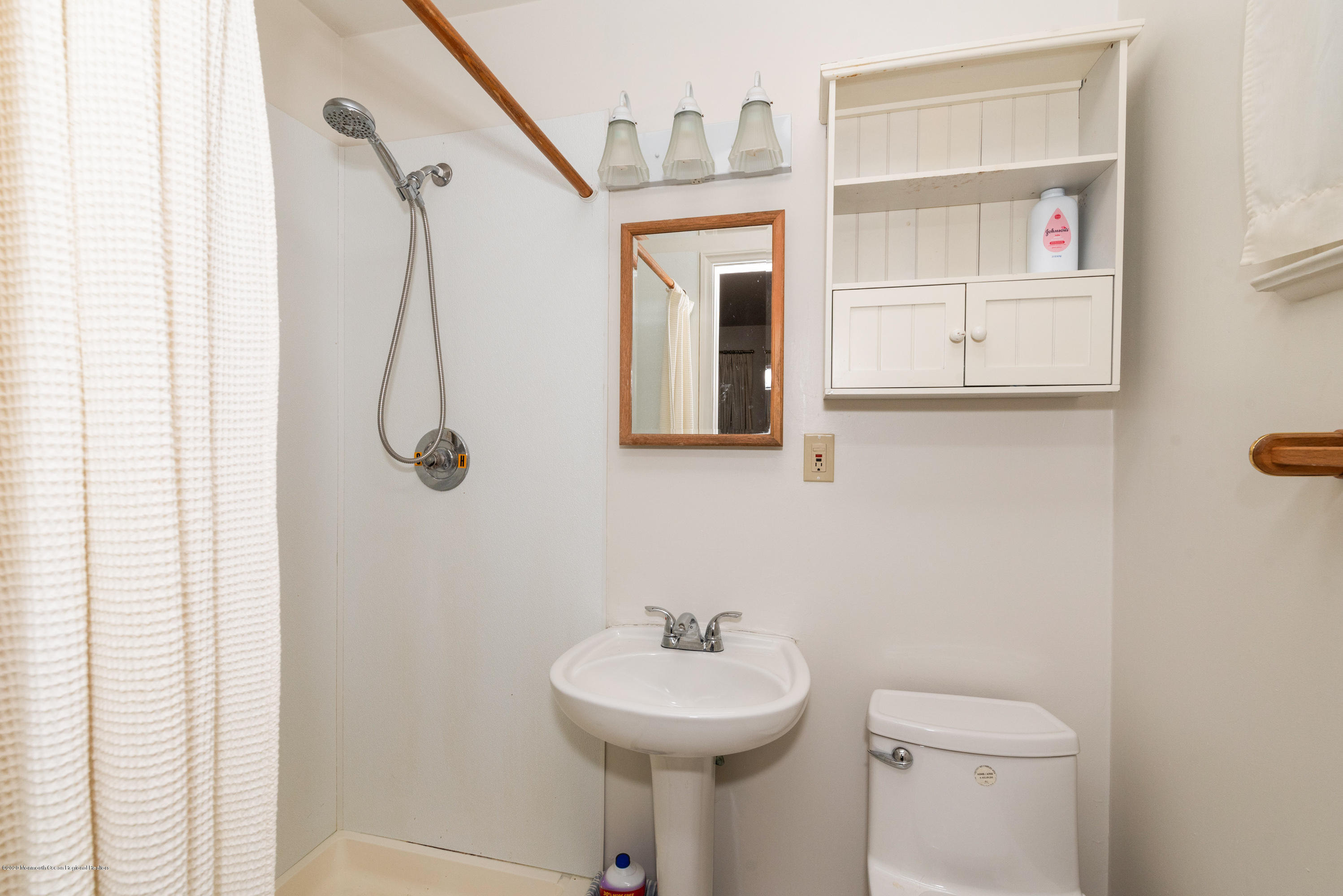 1313 Allaire Road Spring Lake, NJ 07762 - Photo 19 of 23 a bathroom with a sink toilet and a mirror