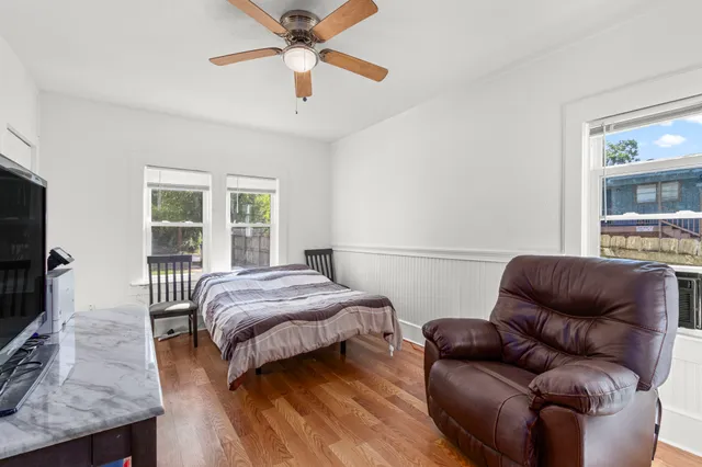 a bedroom with a bed couch and a window