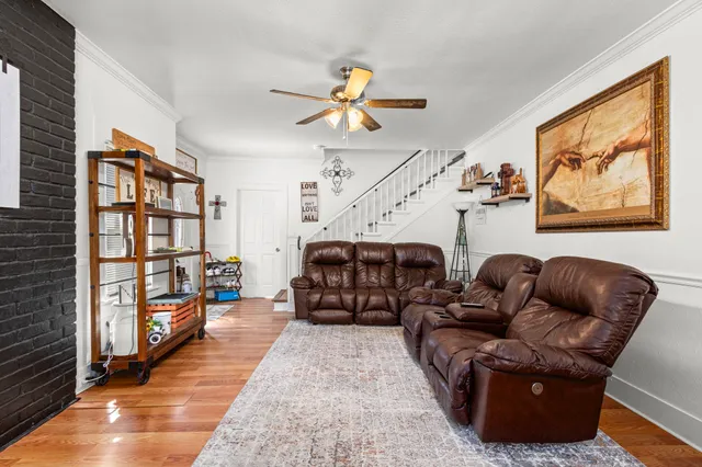 a living room with furniture and a book shelf