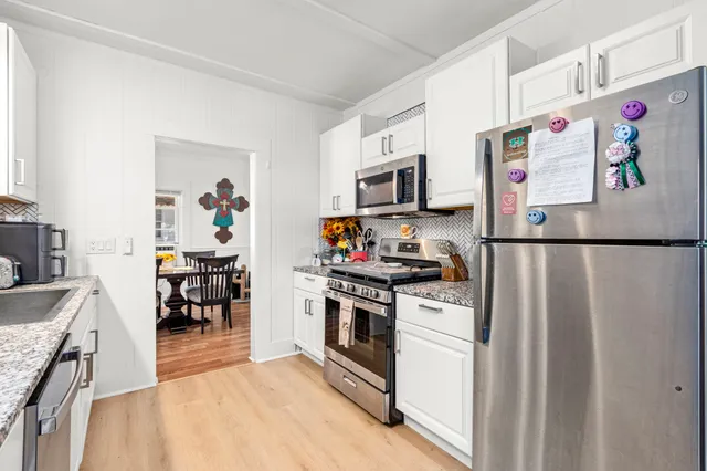 a kitchen with stainless steel appliances granite countertop a refrigerator stove a sink and dishwasher