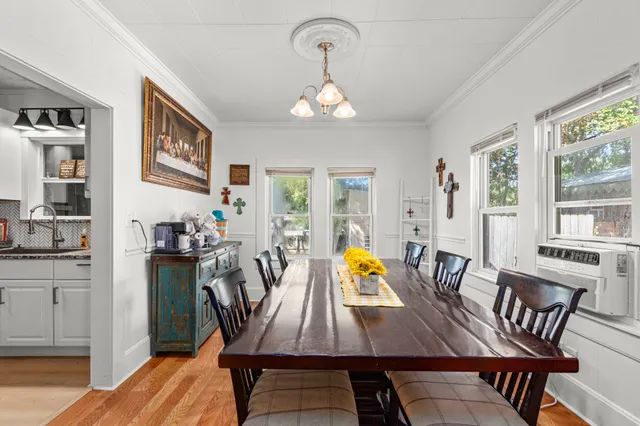 a view of a dining room with furniture and a chandelier