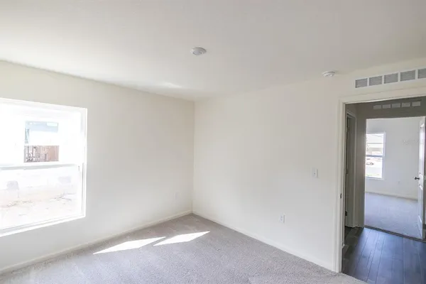 a view of an empty room and a window