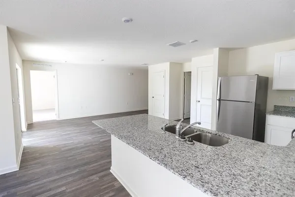 a kitchen with a refrigerator and a sink