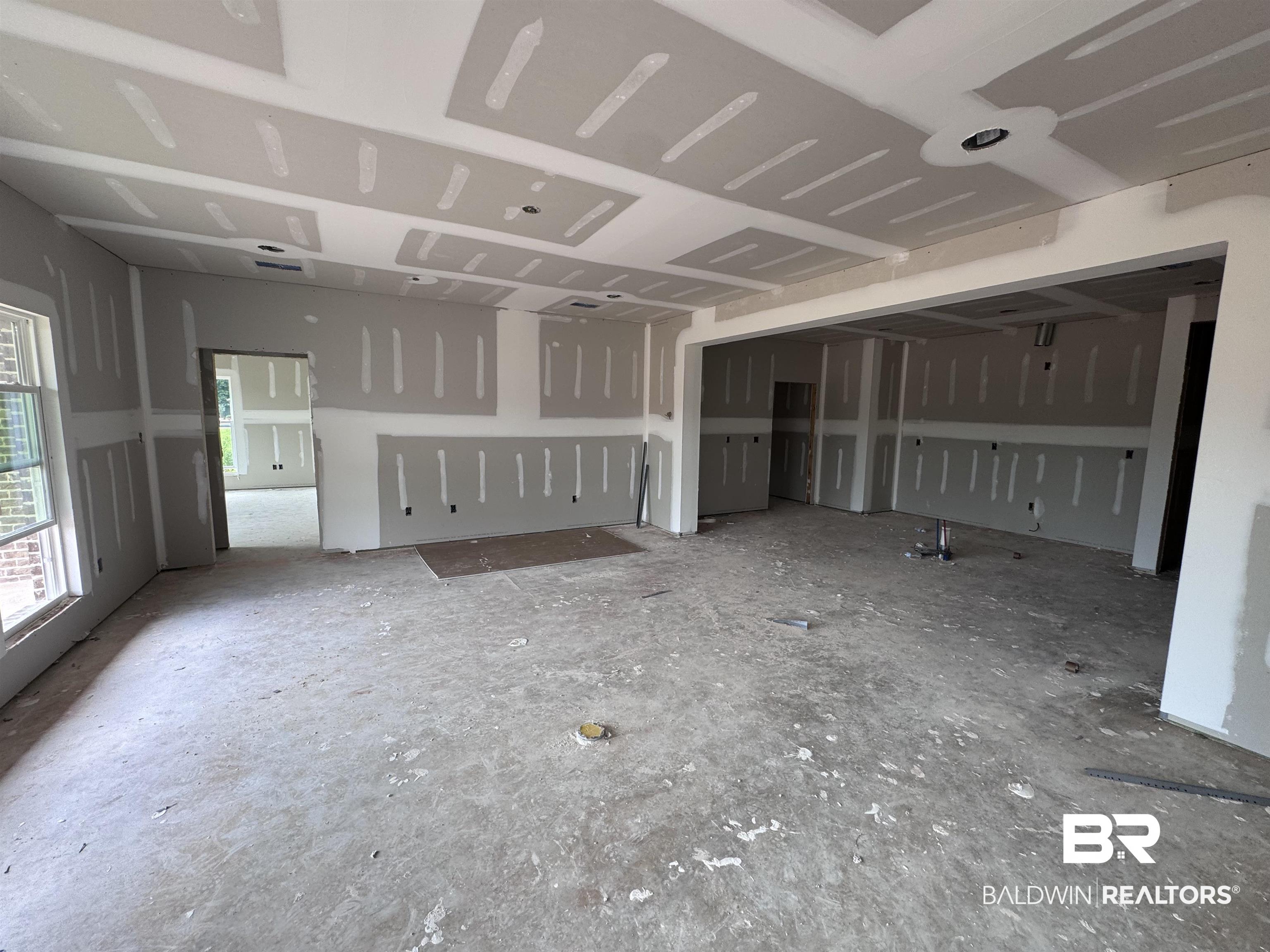 27355 Patch Pl Loop Daphne, AL 36526 - Photo 2 of 17 Open-concept interior featuring drywall installation, recessed ceiling detail, a large windows, and an expansive doorway